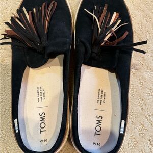 Toms black slip ons.  
Worn once.